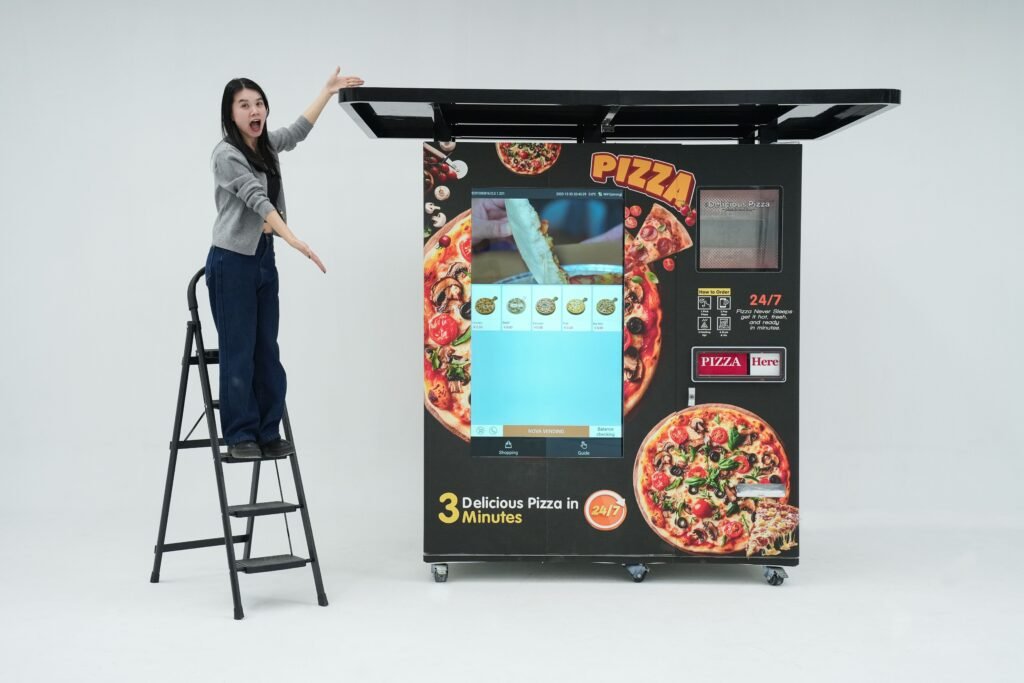 Nova Vending pizza vending machine studio demonstration with host presenting the machine size, exterior design, and large touch screen