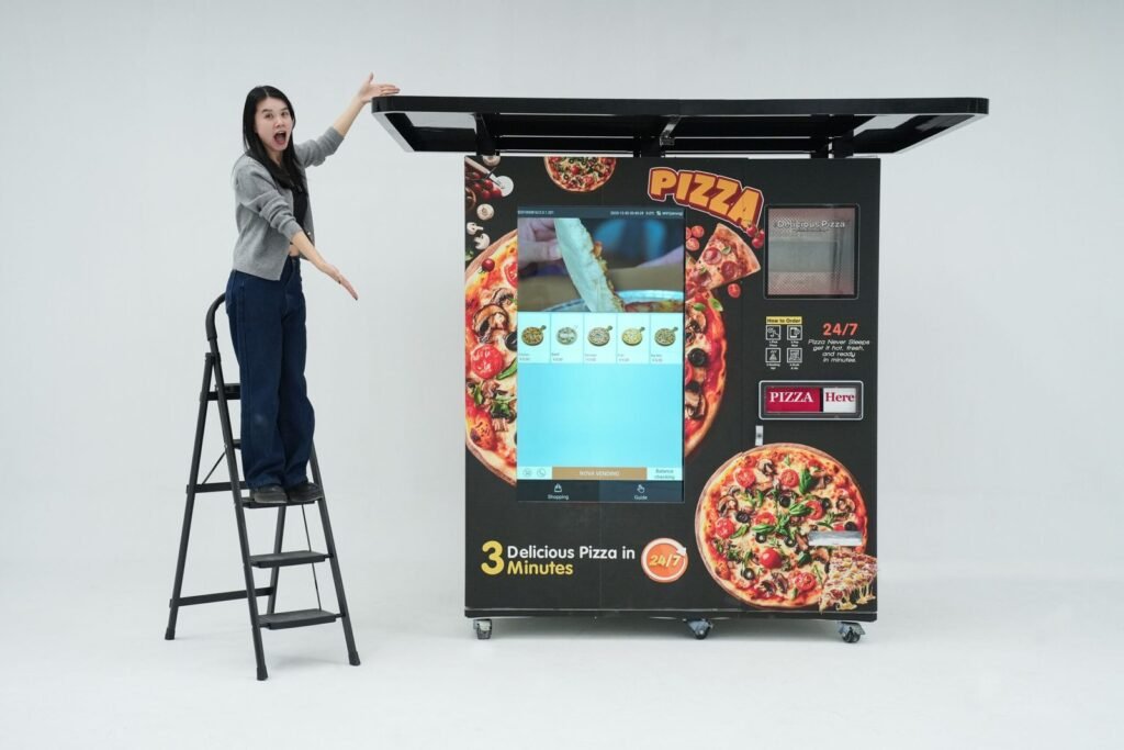 Nova Vending pizza vending machine studio demonstration with host presenting the machine size, exterior design, and large touch screen